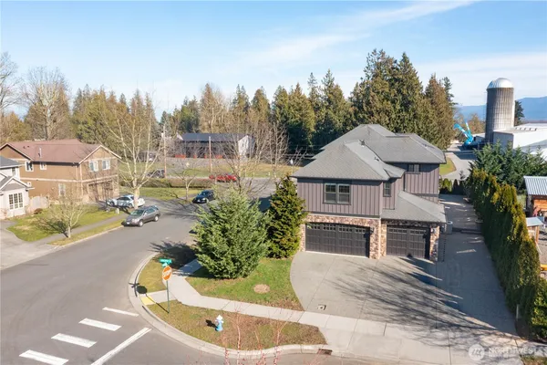 a aerial view of a house with a yard and potted plants