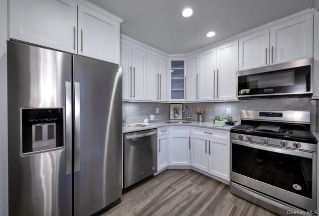 323 Terrace Road, Unit T08323 Bayport, NY 11705 - Photo 4 of 8 a kitchen with stainless steel appliances a refrigerator stove and microwave