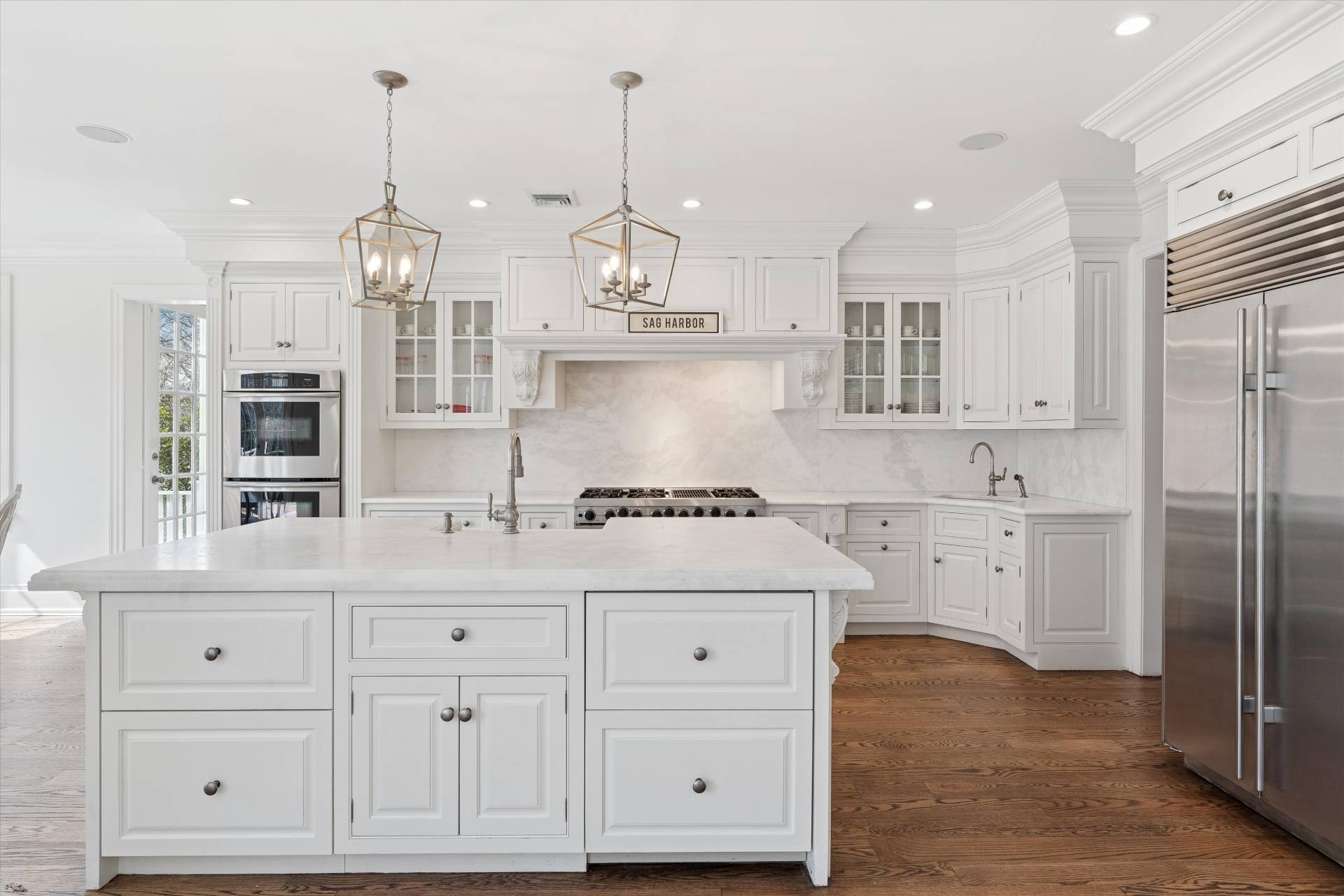 154 Northside Drive Sag Harbor, NY 11963 - Photo 5 of 21 a kitchen with white cabinets and sink