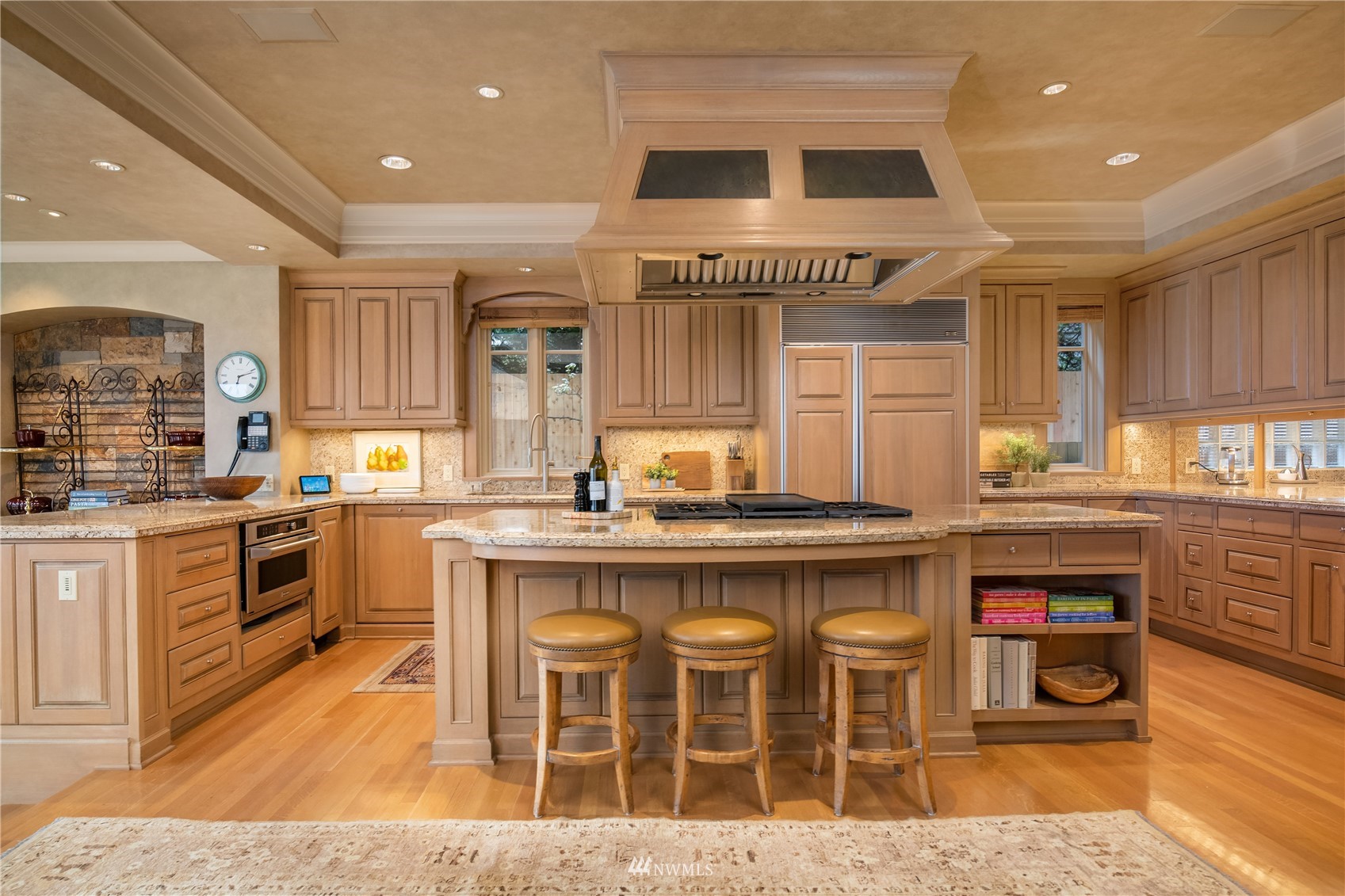 611 Evergreen Point Road Medina, WA 98039 - Photo 11 of 40 a kitchen with stainless steel appliances granite countertop a stove top oven a sink a dining table and chairs