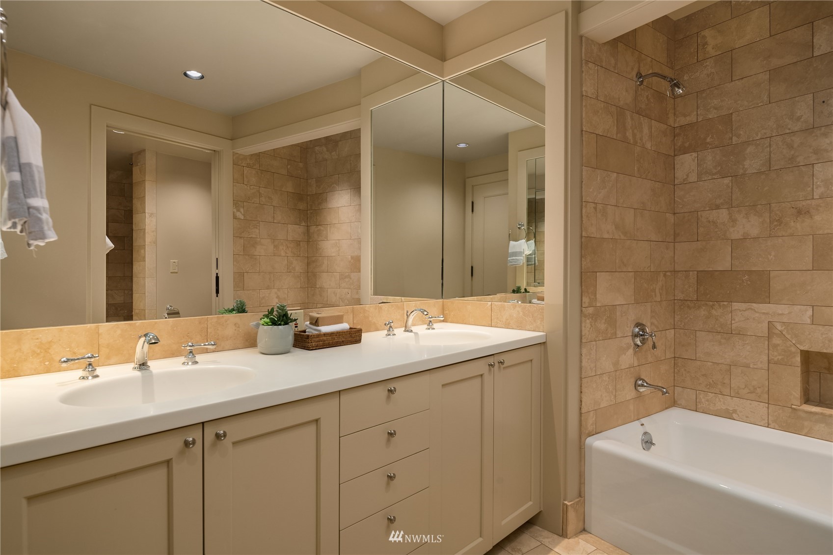 611 Evergreen Point Road Medina, WA 98039 - Photo 32 of 40 a bathroom with a double vanity sink and mirror with bathtub