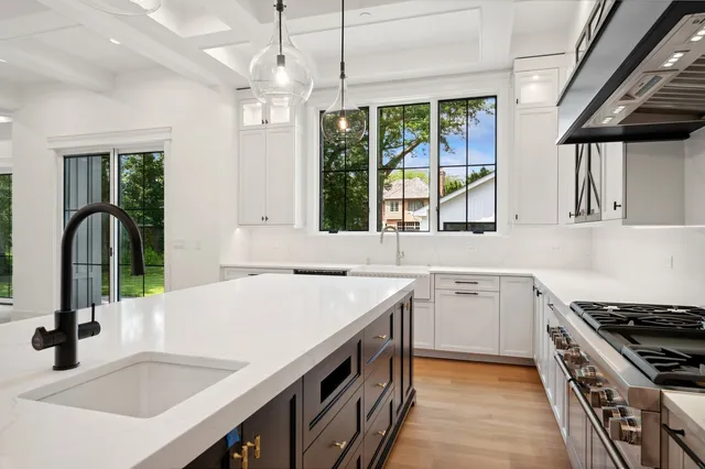 a kitchen with a sink stove and cabinets