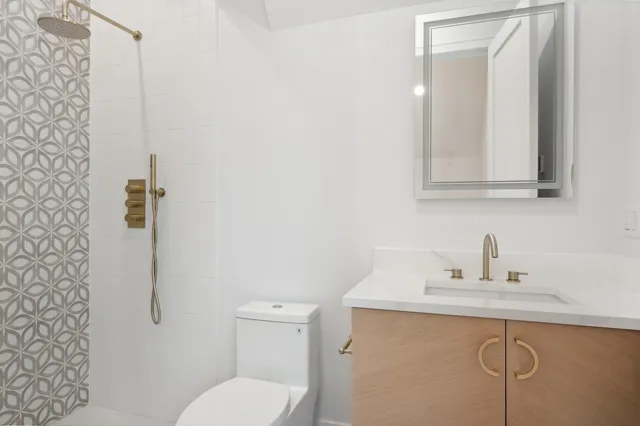 a bathroom with a toilet sink and mirror