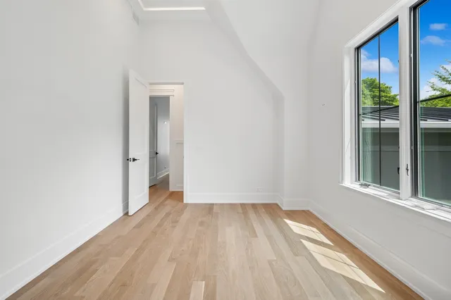a view of a room with wooden floor and a window