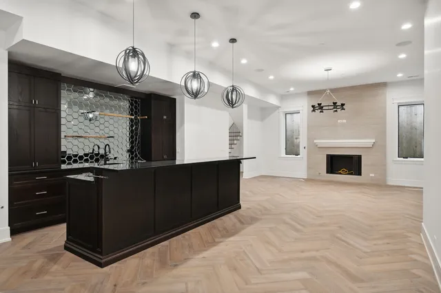 an open kitchen with fireplace and cabinets