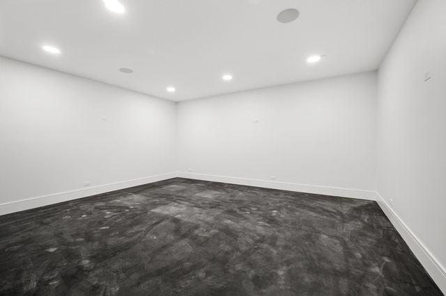 a front view of a house with a garden and yard