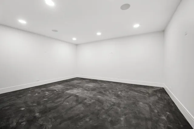 a front view of a house with a garden and yard