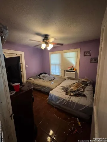 a bedroom with a bed and a dresser in it