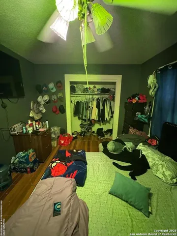 a bedroom with bed and a mirror