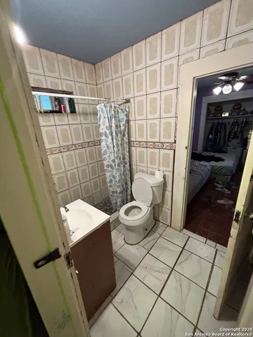 a view of a room with gym equipment and a large window