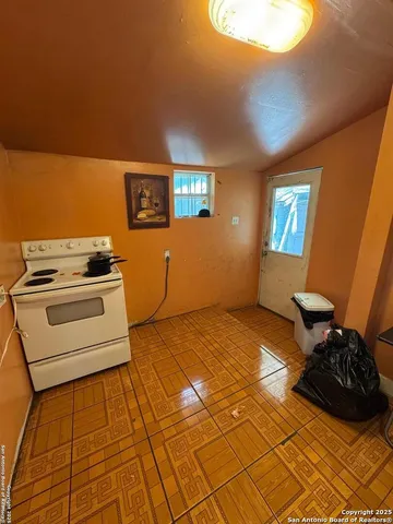 a kitchen with a sink and a stove top oven