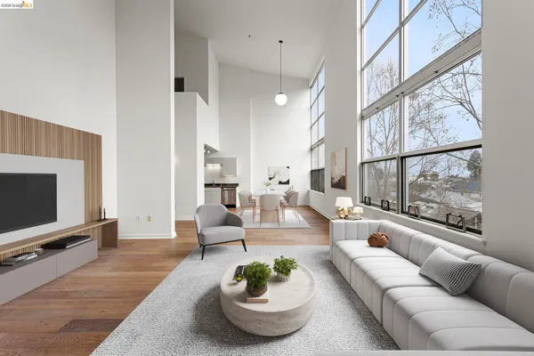 a living room with furniture tv and a large window