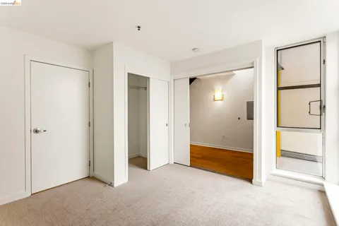 a bathroom with a granite countertop toilet sink and mirror