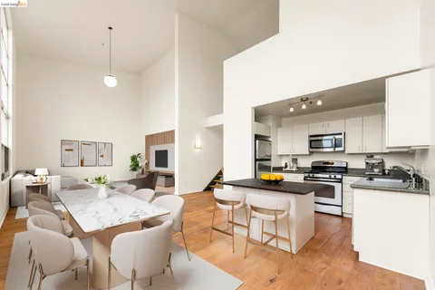 a view of a kitchen with a sink stove and wooden floor