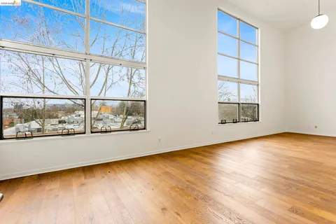 an empty room with wooden floor and a window