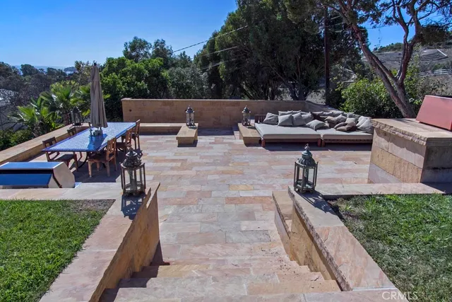 a view of a terrace with chairs and wooden fence