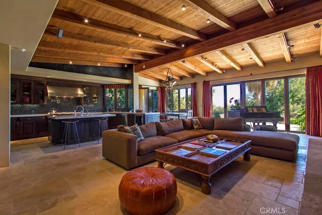 a view of a porch with a floor to ceiling window and potted plants