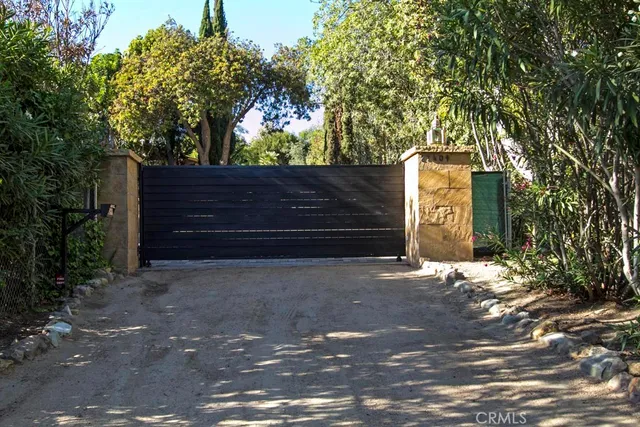 a view of a chair and tables in the backyard of the house