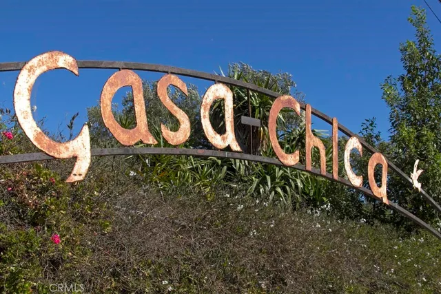a view of a grassy field with trees in the background