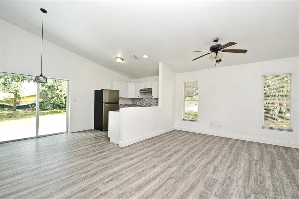 1502 West 16th Street Sanford, FL 32771 - Photo 11 of 12 a view of a kitchen with microwave and wooden floor