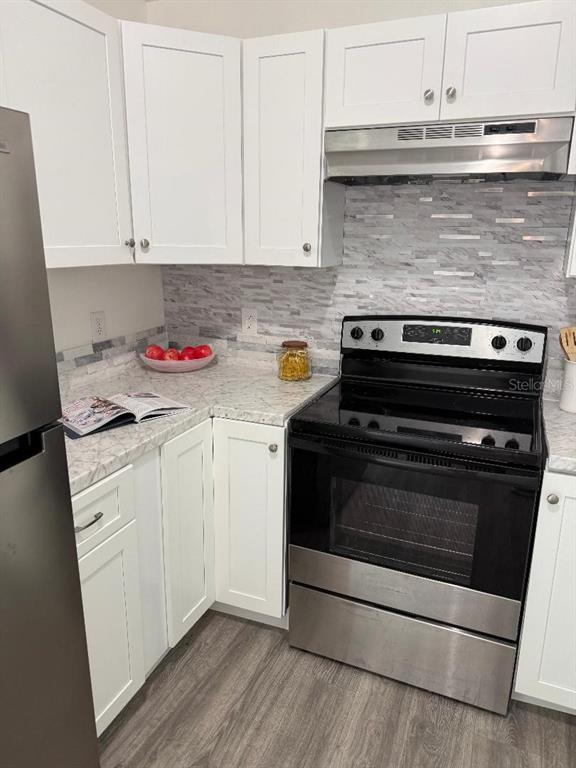 1502 West 16th Street Sanford, FL 32771 - Photo 7 of 12 a stove top oven sitting inside of a kitchen