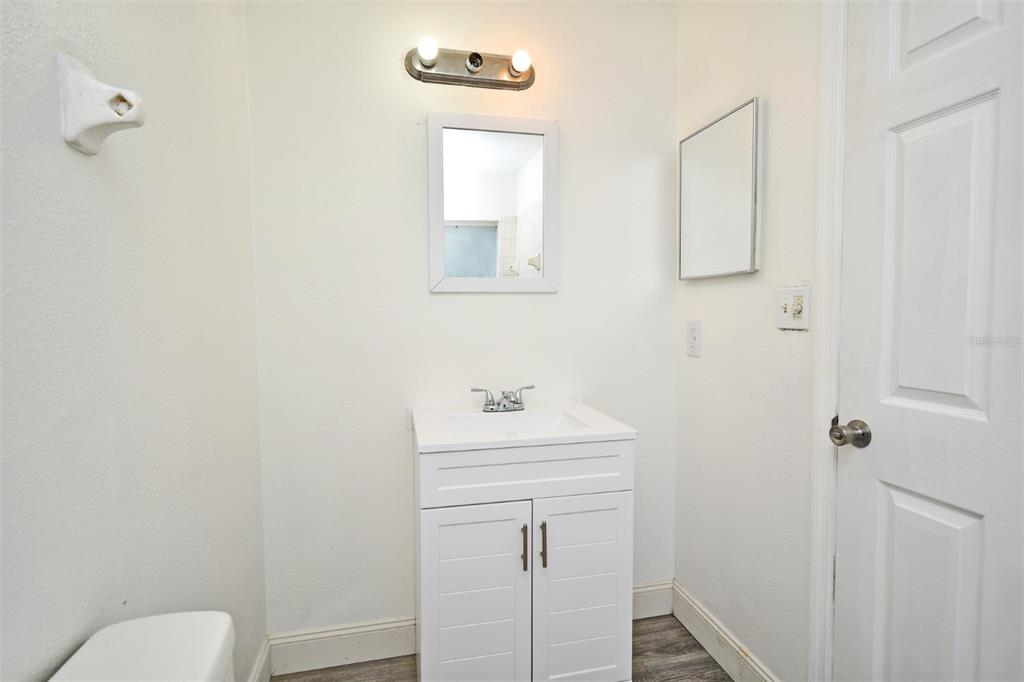 1502 West 16th Street Sanford, FL 32771 - Photo 9 of 12 a bathroom with a sink a toilet and mirror