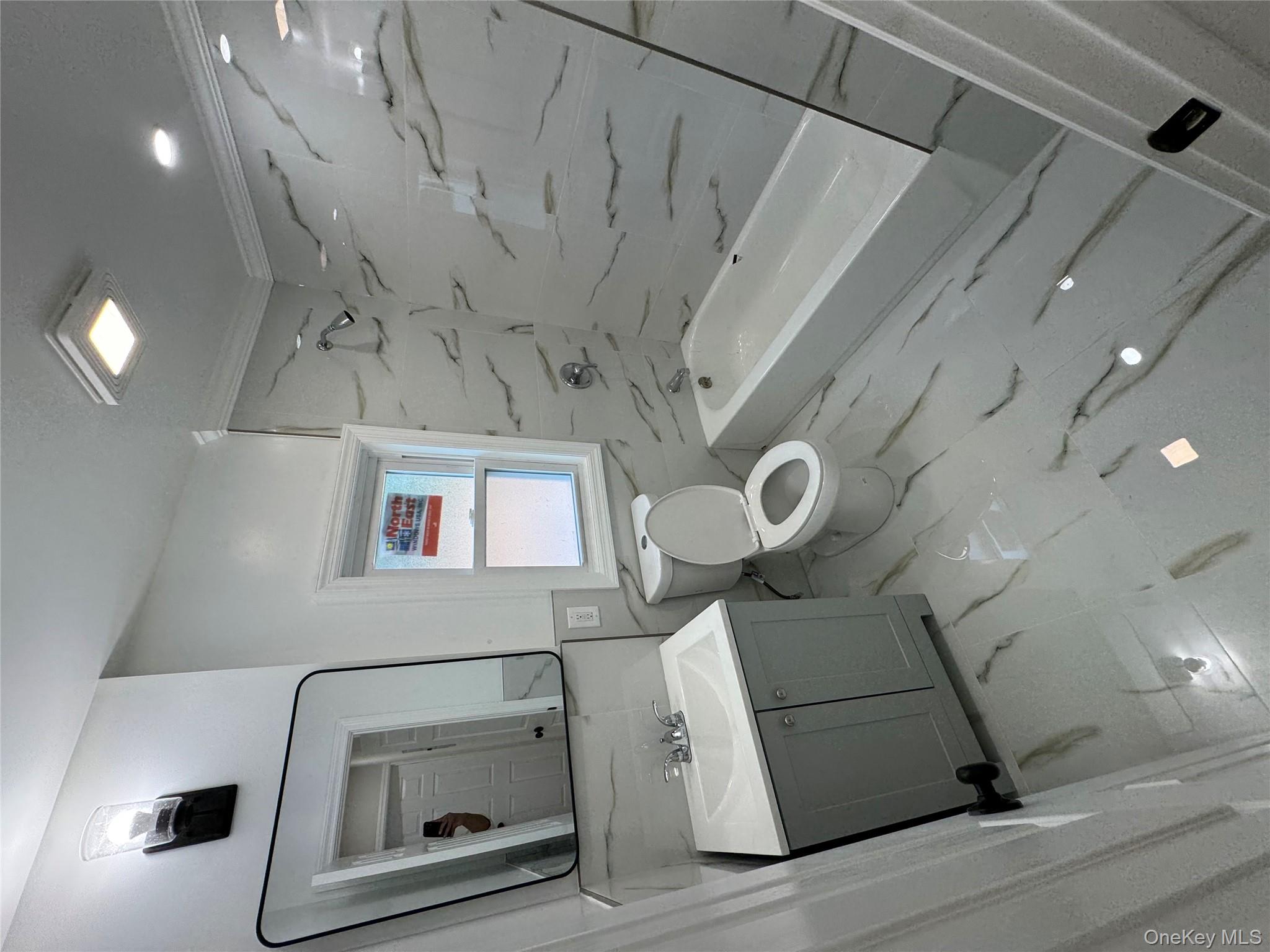 194-45 Murdock Avenue Queens, NY 11412 - Photo 14 of 23 a bathroom with a double vanity sink a toilet and mirror