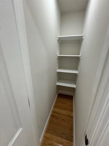 a hallway view with staircase