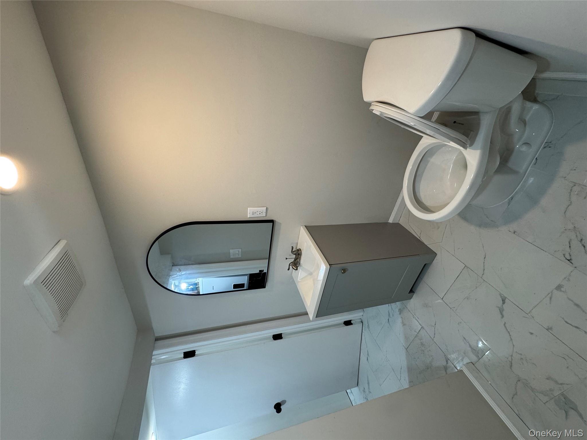 194-45 Murdock Avenue Queens, NY 11412 - Photo 20 of 23 a bathroom with a toilet sink and mirror