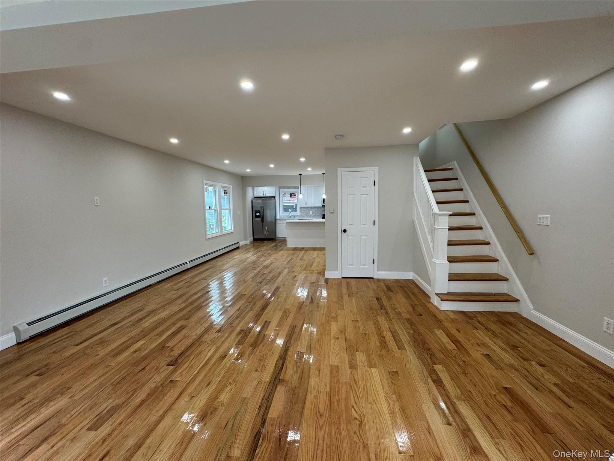 194-45 Murdock Avenue Queens, NY 11412 - Photo 2 of 23 a view of kitchen and hall with wooden floor
