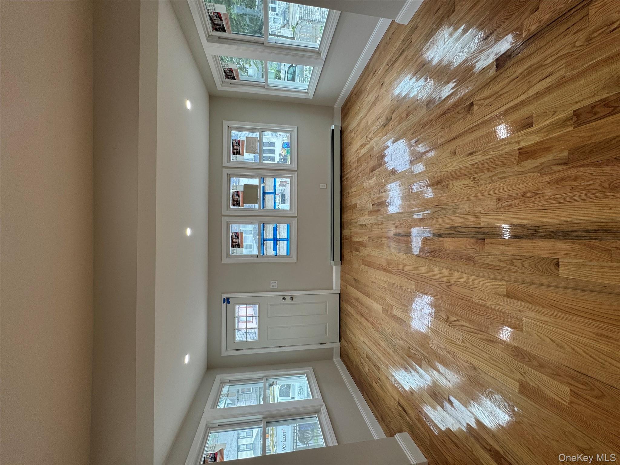 194-45 Murdock Avenue Queens, NY 11412 - Photo 3 of 23 a view of empty room with wooden floor and fan