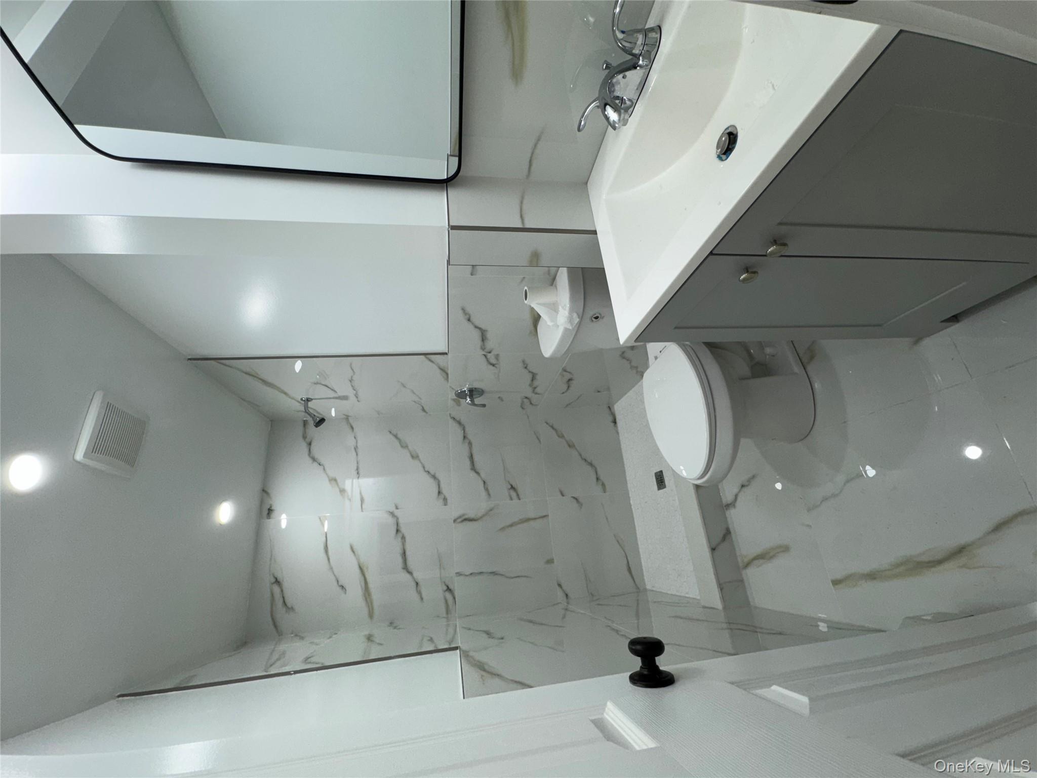 194-45 Murdock Avenue Queens, NY 11412 - Photo 9 of 23 a bathroom with a sink a toilet and mirror