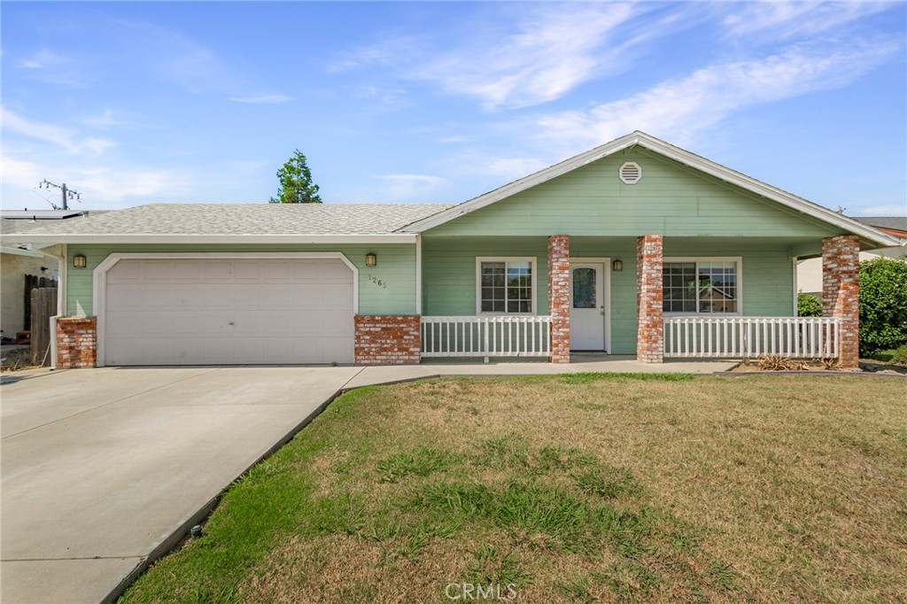 a front view of a house with a garden and plants