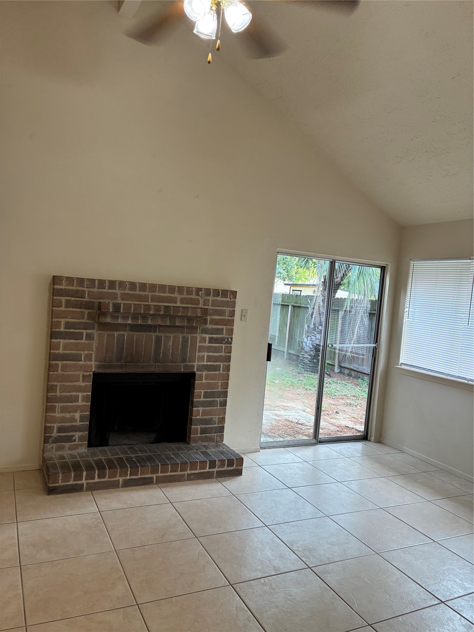 16230 Cutten Road Houston, TX 77070 - Photo 12 of 25 a view of an empty room with glass door and a fireplace