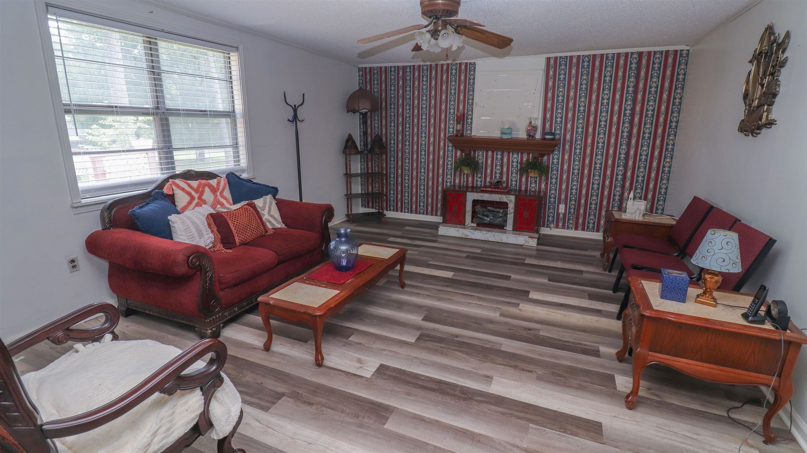 1675 Tabernacle Road Covington, TN 38019 - Photo 7 of 21 a living room with furniture a fireplace and a window