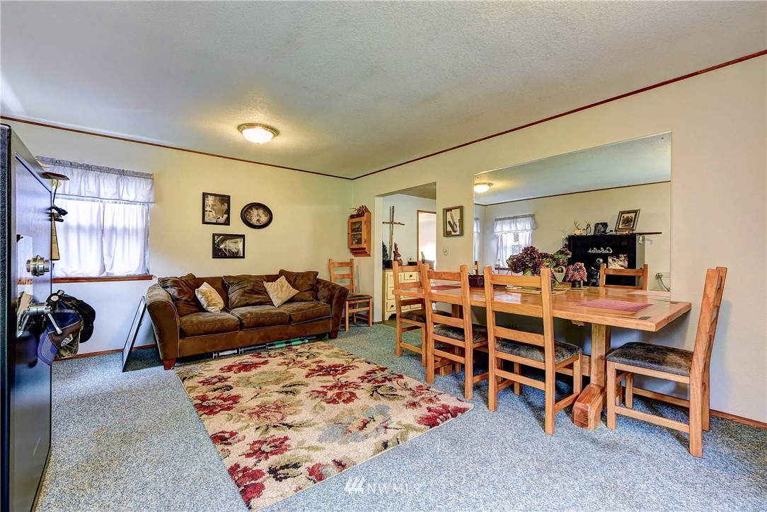 3625 Newberg Road Snohomish, WA 98290 - Photo 4 of 25 a living room with furniture a dining table and chairs