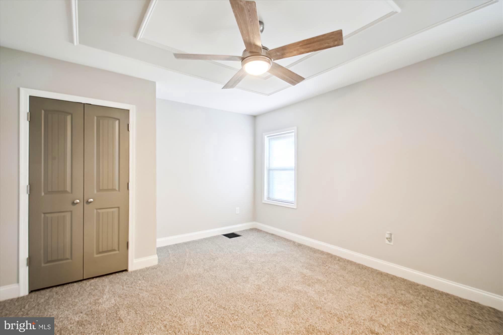 106 Charles Road Linthicum Heights, MD 21090 - Photo 13 of 44 an empty room with a ceiling fan and window