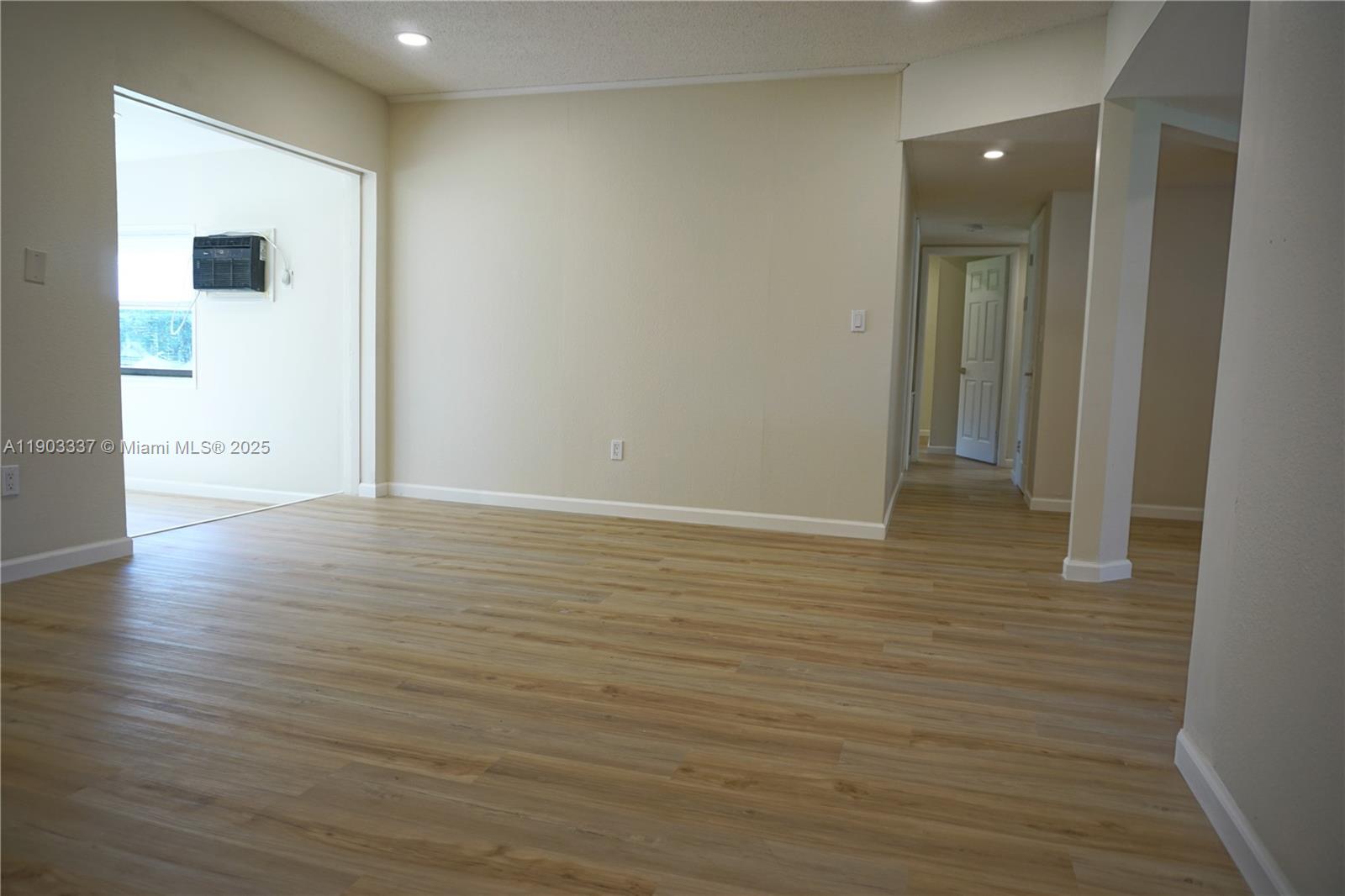 971 Fulton Lane Northeast Palm Bay, FL 32905 - Photo 18 of 29 a view of an empty room with wooden floor