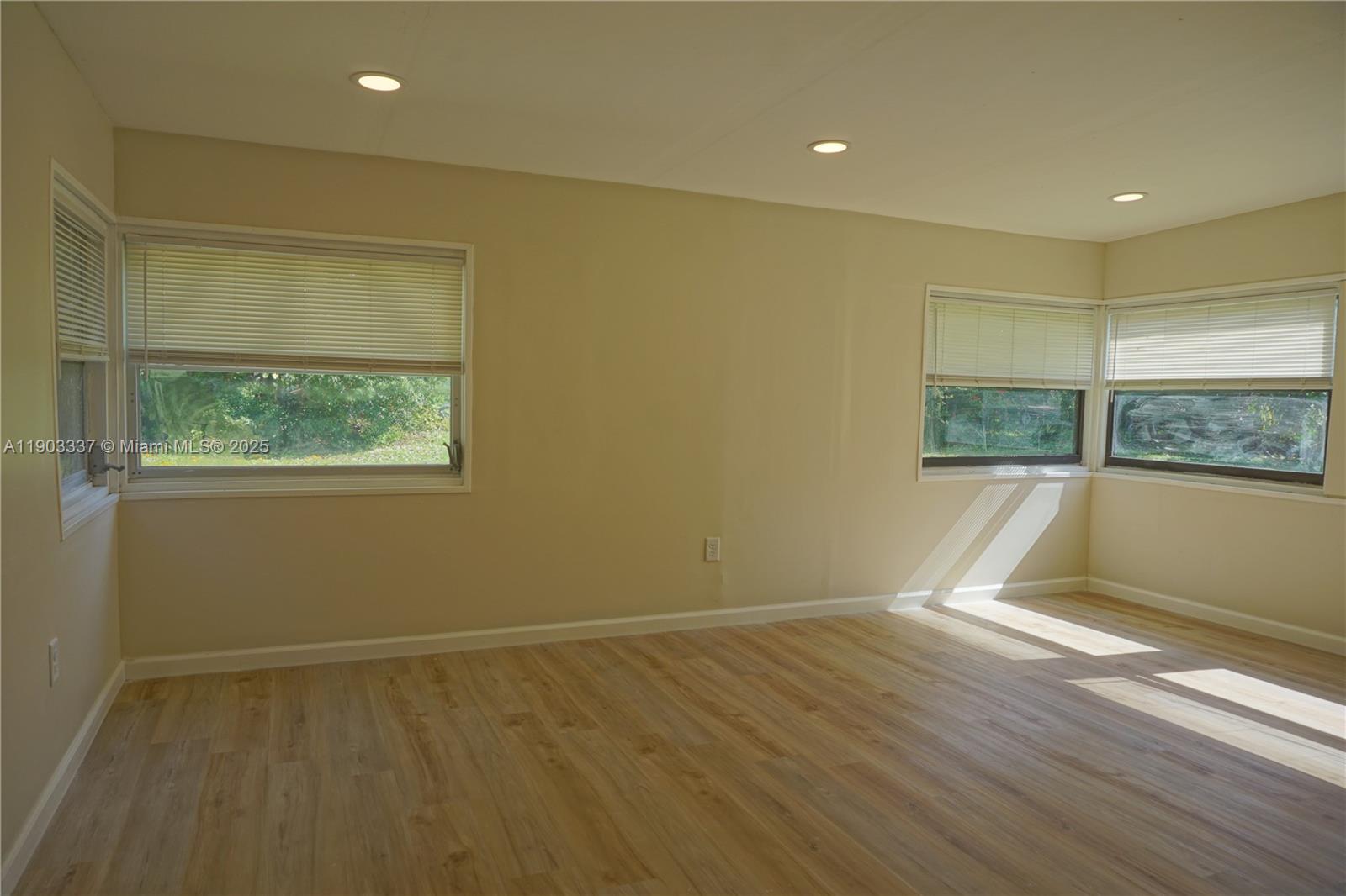 971 Fulton Lane Northeast Palm Bay, FL 32905 - Photo 20 of 29 a view of empty room with wooden floor and fan