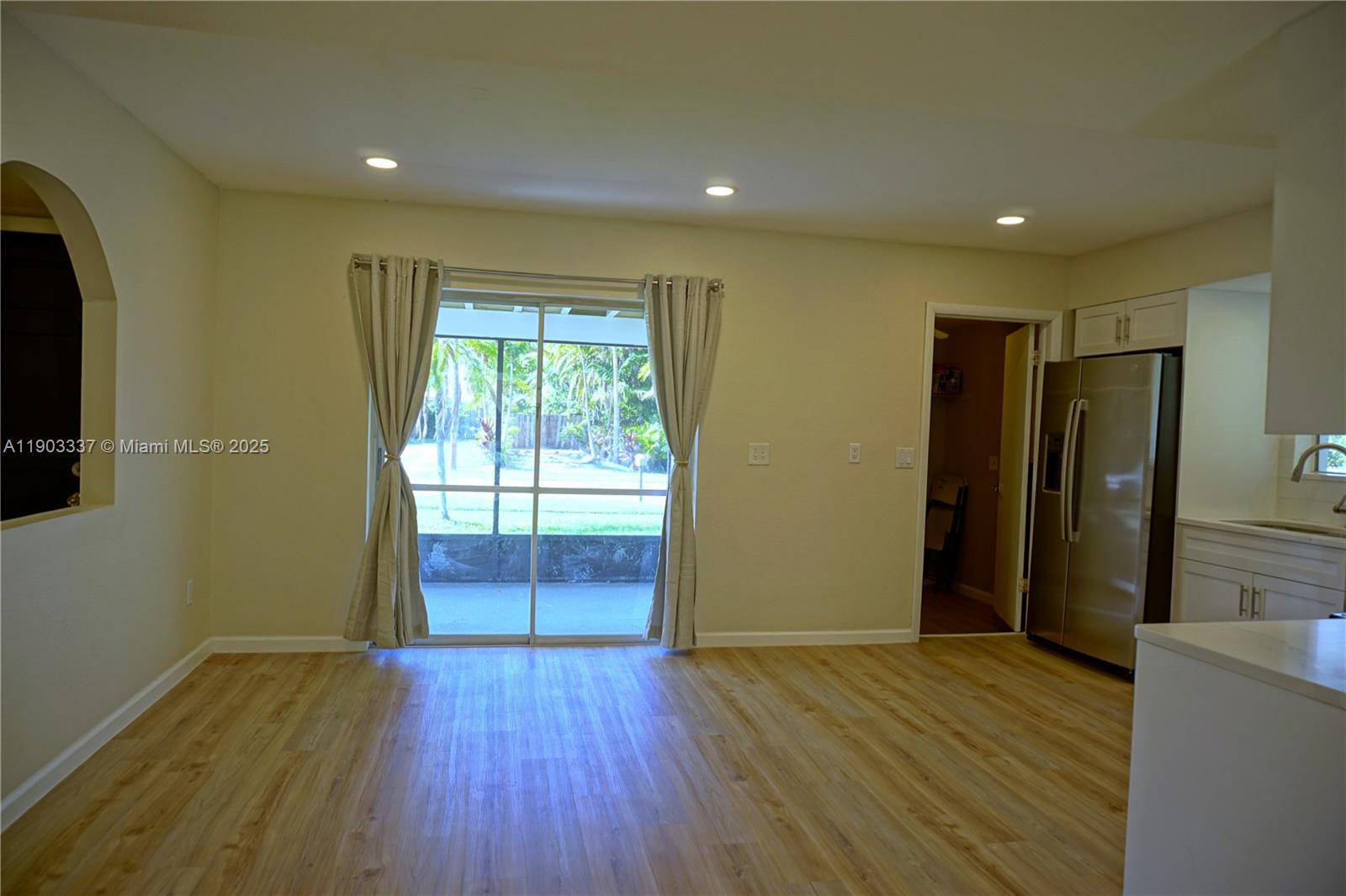 971 Fulton Lane Northeast Palm Bay, FL 32905 - Photo 10 of 29 a view of hallway with a window and wooden floor