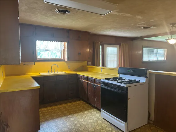 a kitchen with stainless steel appliances granite countertop a sink and a stove
