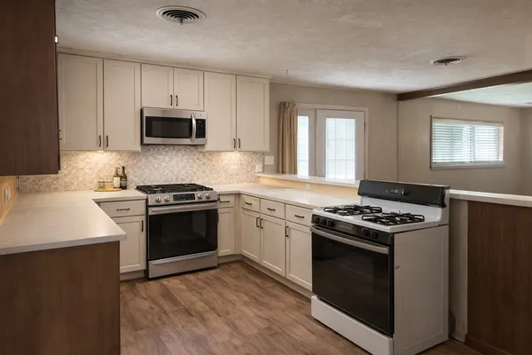 a kitchen with a stove and a microwave