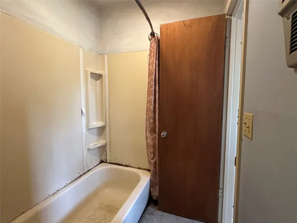a bathroom with a tub and shower