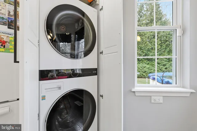 a close view of a washer and dryer in a small bathroom