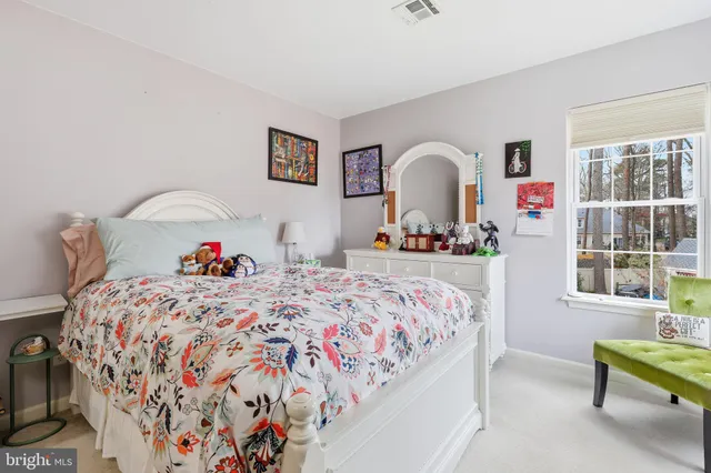 a bedroom with bed and a window