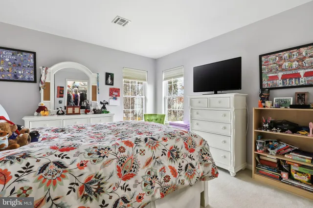 a bedroom with bed and flat screen tv
