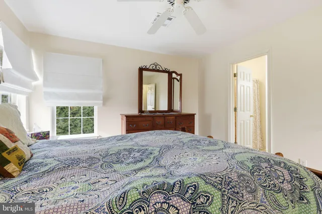 a bedroom with a large bed and a window