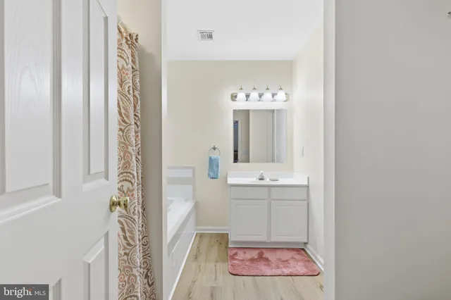 a bathroom with a sink a mirror and a shower