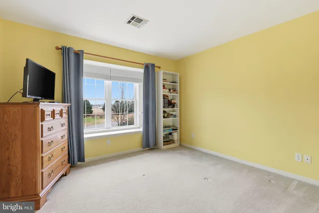 a view of an empty room with a kitchen