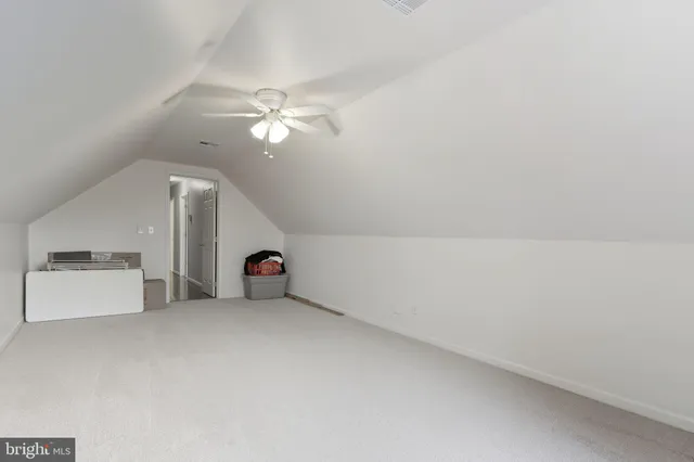 en empty room with windows and fan